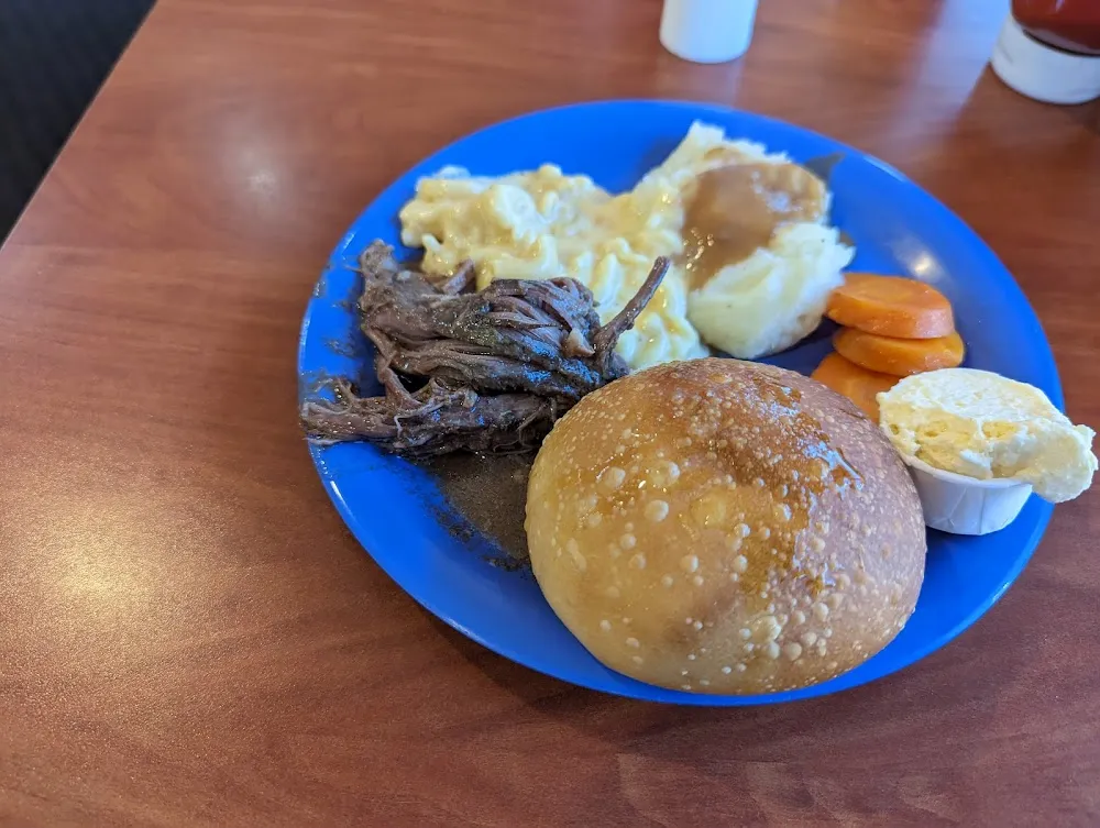 Pot Roast with Carrots Mashed Potatoes and a Roll